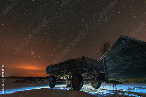 Sunset at night time with agricultural land in foreground and stars in background