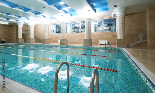 Indoor public swimming pool interior in fitness gym club. healthy concept