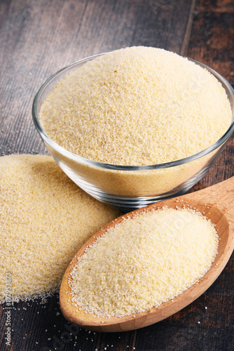 Fotografie Bowl of semolina on wooden table