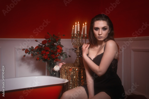 Beautiful sexy woman in a red bathroom
