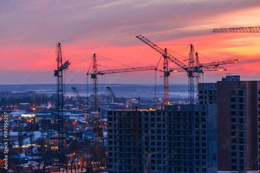 High-rise buildings construction site on crimson sunset sky background. Voronezh, Russia