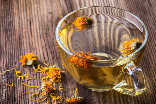 Calendula (Marigold) herbal tea in a transparent glass mug