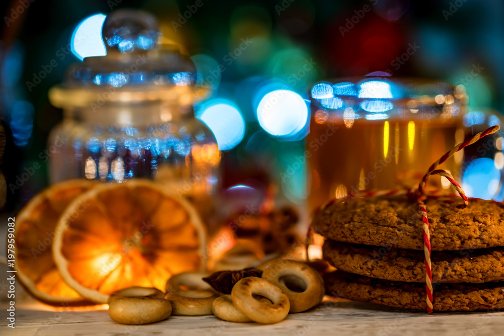 Cozy still life of tea, christmas light and pastry