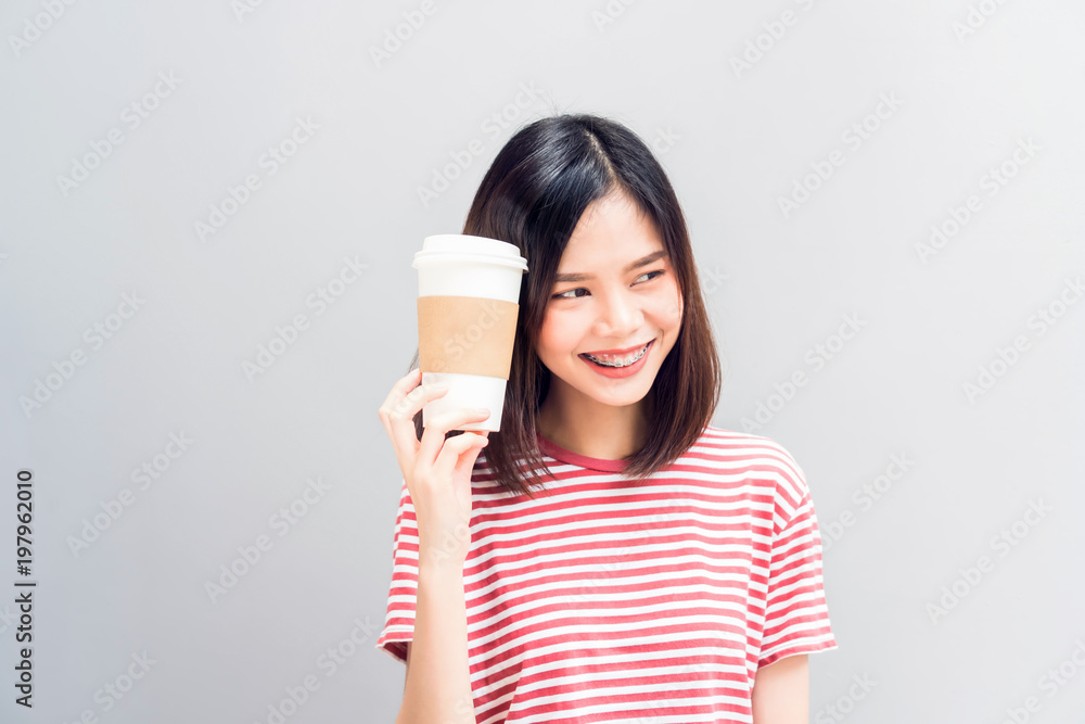 Young girl happy smile and cheerful in red dress hold a white coffee mug in hand. Concept summer travel. Young girl happy smile and cheerful in red dress hold a white coffee mug in hand. Concept summer travel.