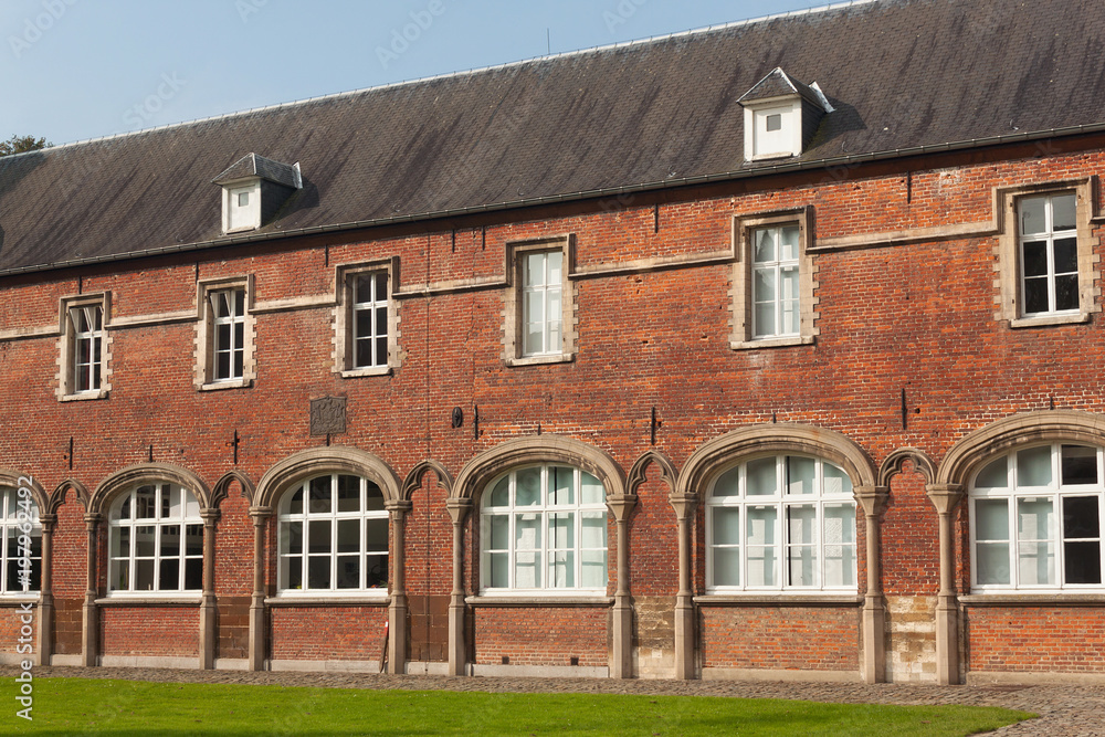 Walls of the Arenberg Castle in Leuven, Belgium. The architectural style is in large part traditionally Flemish, with sandstone window frames and brick walls.