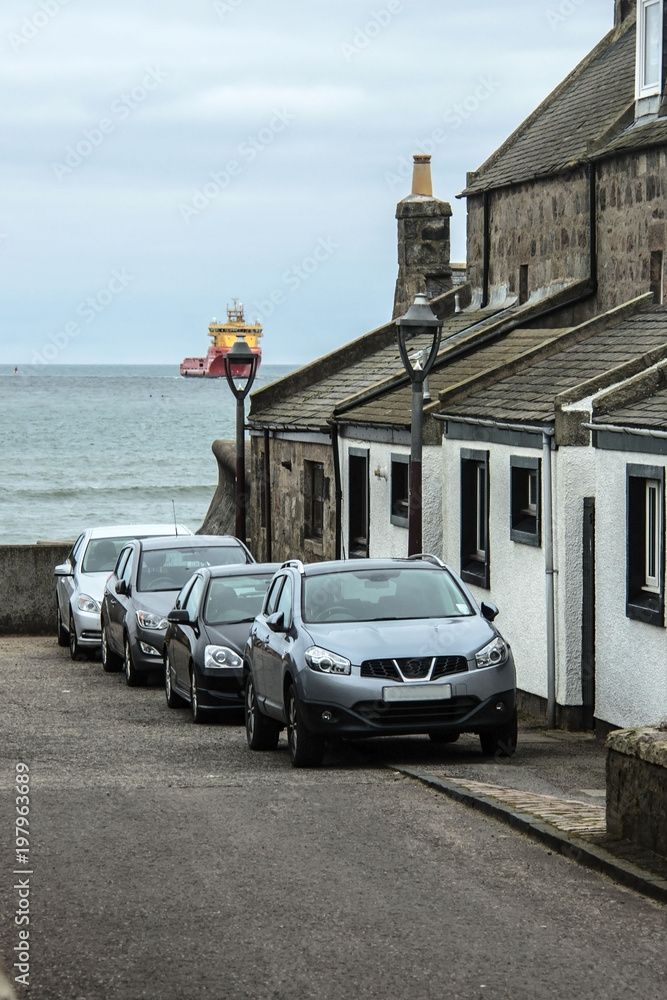 Naklejka premium Aberdeen Scotland, UK. Coastline and ship entering harbour. 