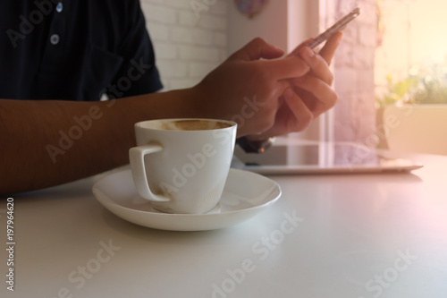 Man using a smart phone in a coffee shop.