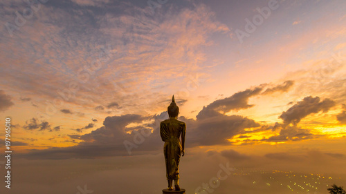 Sunrise, Golden buddha statue in Khao Noi temple, Nan Province, Thailand