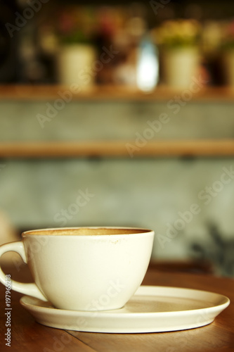 Fototapeta Naklejka Na Ścianę i Meble -  Coffee cup in coffee shop interior