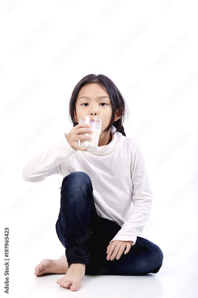 Little Asian girl holding a glass of milk Little Asian girl holding a glass of milk