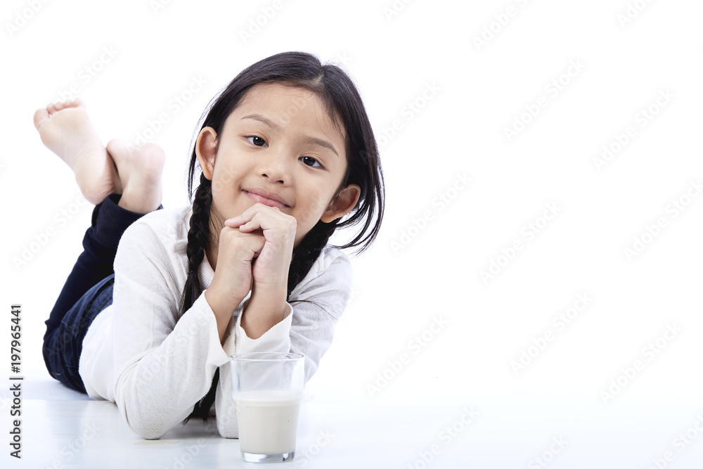 Little Asian girl holding a glass of milk Little Asian girl holding a glass of milk