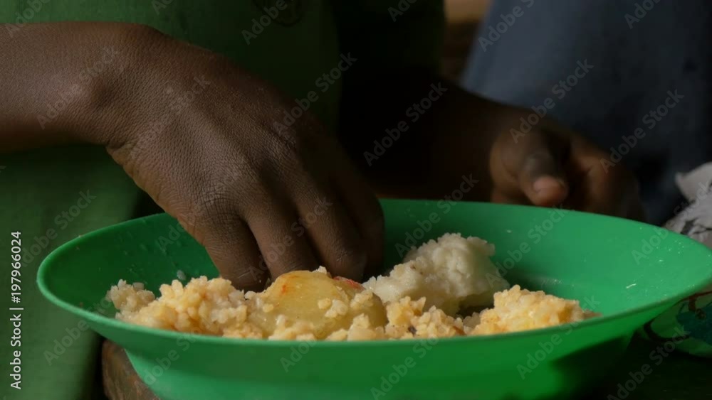 Eating with hands from a green plate Eating with hands from a green plate