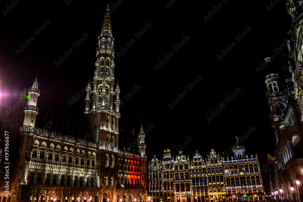The townhall and belfry tower of Brussels is illuminated and lit up at night, Belgium