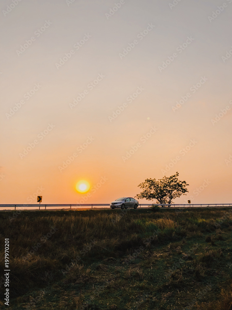 Highway road in the rice farm with sunset background in Surin. Highway road in the rice farm with sunset background in Surin.