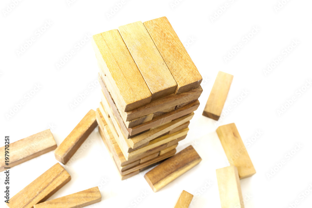 The tower from wooden blocks and man's hand take one block