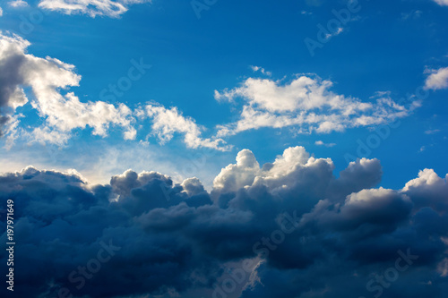 Photo of a blue sky with dark clouds