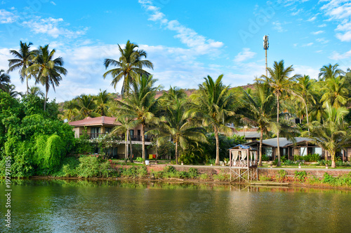 River on the beach in Mandrem with views of buildings in North Goa.India 