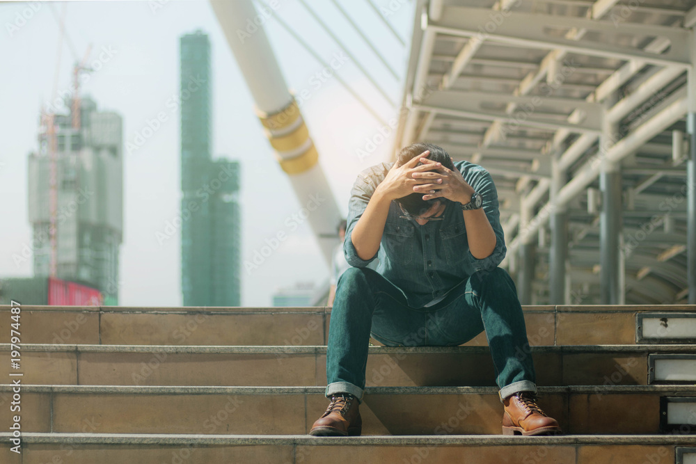 Fotografie Young man with failure on stairway.