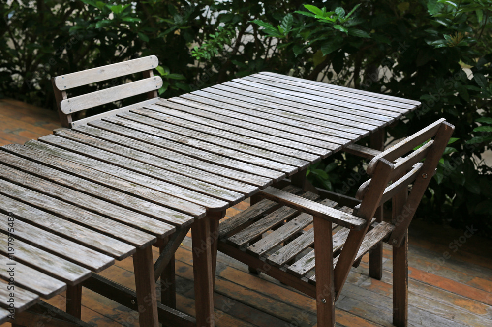 Empty wooden table and chair in the garden.