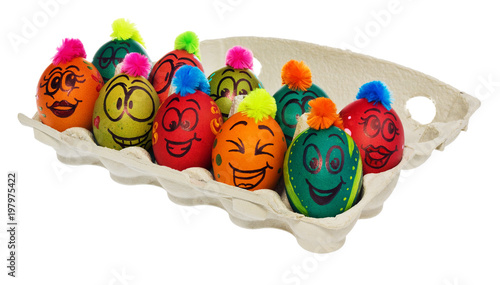 Easter eggs, hand-painted with smiling and terrified cartoon faces put in a cardboard box, container for eggs.