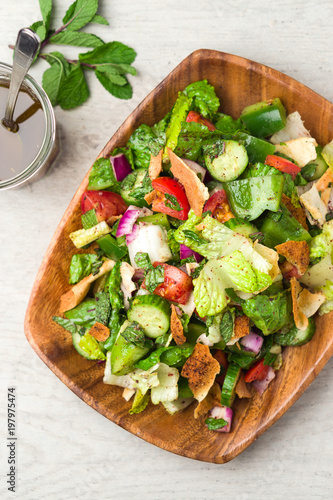 Healthy fattoush salad from above. The key ingredient in this middle eastern dish is the toasted pita bread which is mixed with healthy vegetables, herbs and a dressing made with lemon and sumac. photo