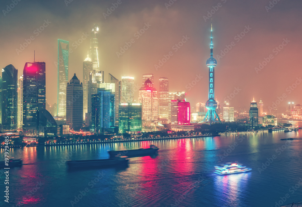 Aerial view on big modern city by night. Shangai, China. Nighttime skyline with illuminated skyscrapers.