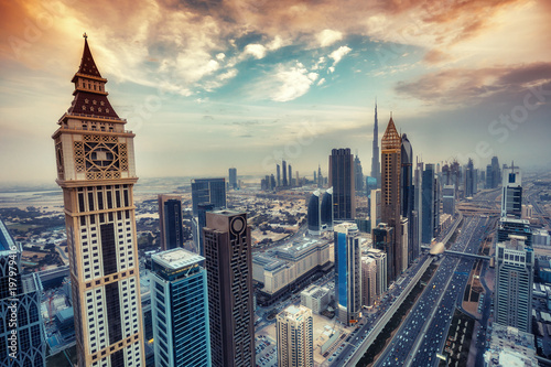 Aerial view on skyscrapers of Dubai  UAE  at sunset. Scenic cityscape with dramatic clouds. Toned travel and architectural background.