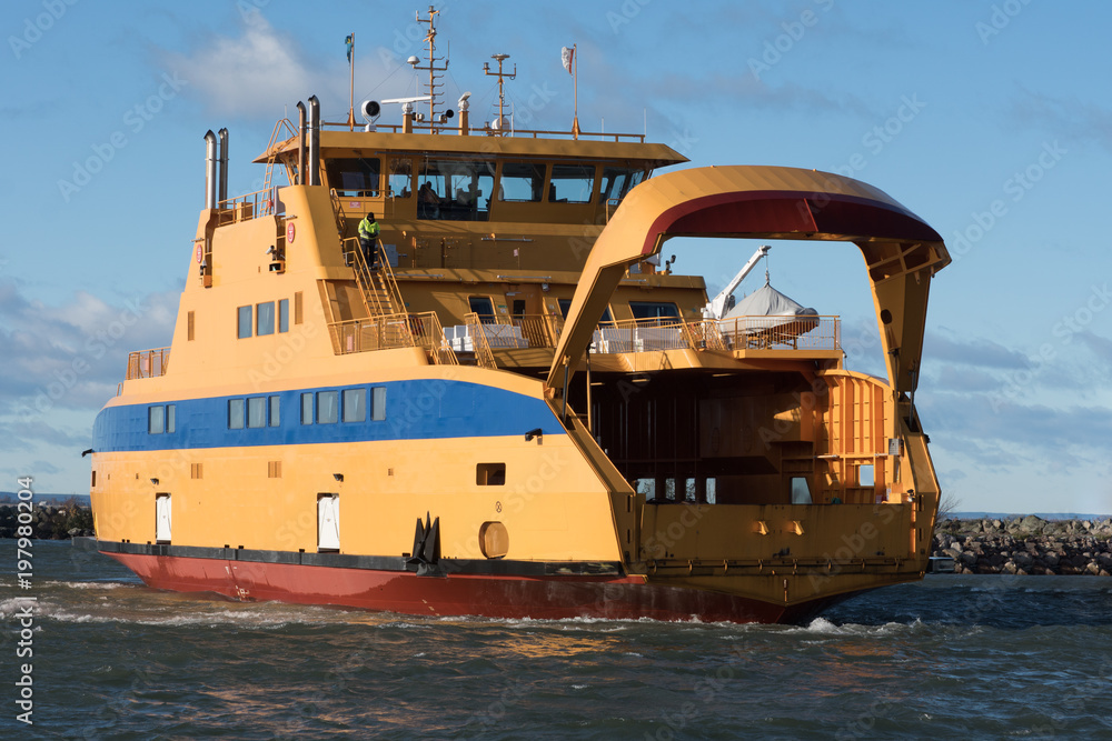 Fototapeta premium Large yellow vehicle ferry arriving to the port