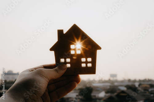 House model in home insurance broker agent ‘s hand or in salesman person. Real estate agent offer house, property insurance and security, affordable housing concepts photo
