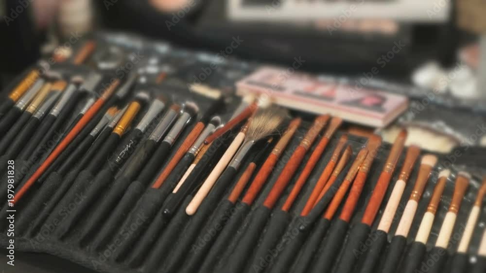 Kit of different brushes for make-up on the table indoor at professional salon. Close-up Kit of different brushes for make-up on the table indoor at professional salon. Close-up