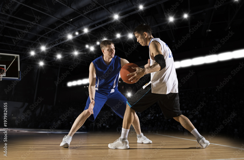 Fototapeta premium Two basketball players in action