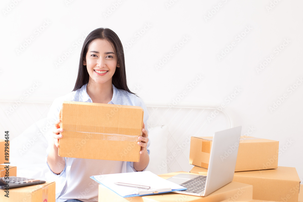 Young asian woman business owner work and white down address for deliver at home, woman business owner concept, 20-25 year old. Young asian woman business owner work and white down address for deliver at home, woman business owner concept, 20-25 year old.