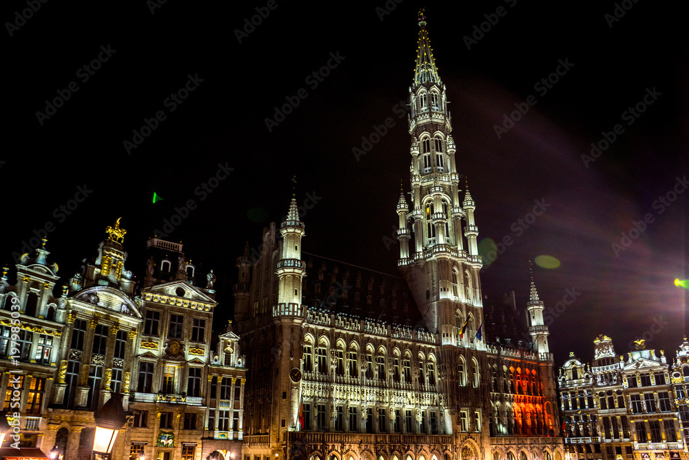 The townhall and belfry tower of Brussels is illuminated and lit up at night, Belgium