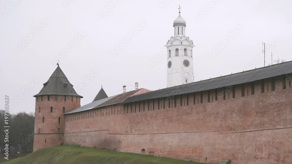 Old tower and historical brick walls of Kremlin of Veliky Novgorod, Russia in overcast autumn day Old tower and historical brick walls of Kremlin of Veliky Novgorod, Russia in overcast autumn day