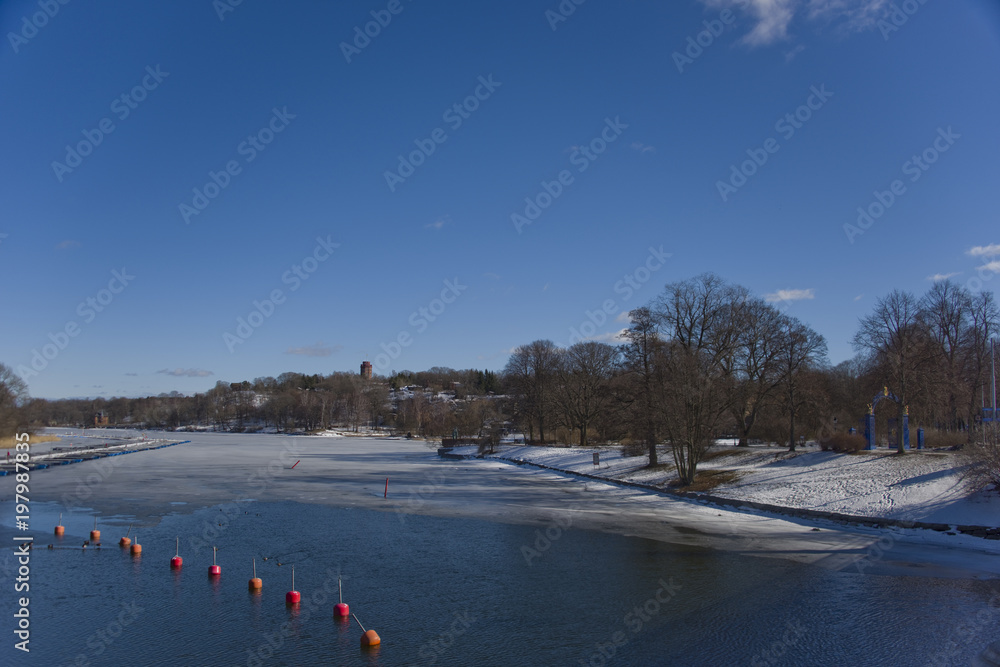 A sunny day at Djurgarden in Stockholma late winter day with ice and snow