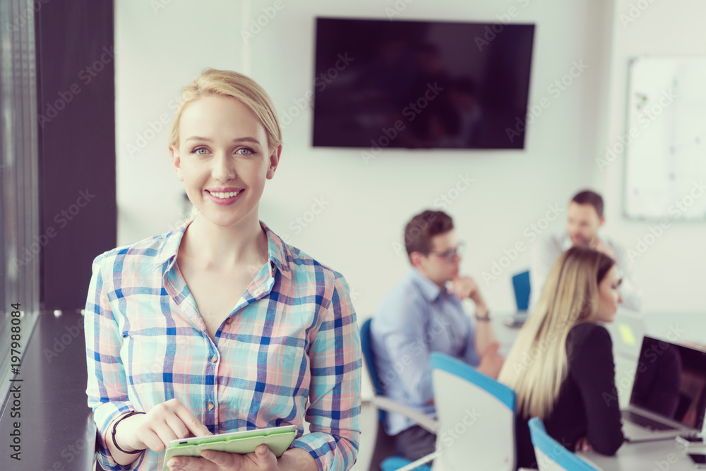 Pretty Businesswoman Using Tablet In Office Building by window Pretty Businesswoman Using Tablet In Office Building by window