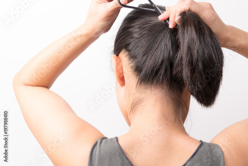 rear view of women tightening the hair, lifestyle concept