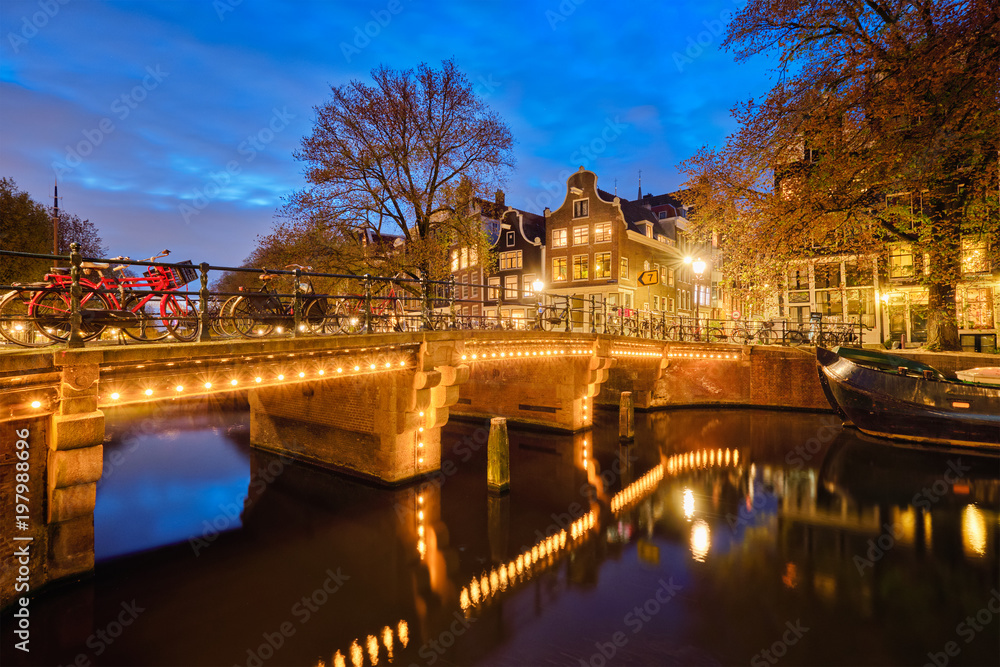 Amterdam canal, bridge and medieval houses in the evening