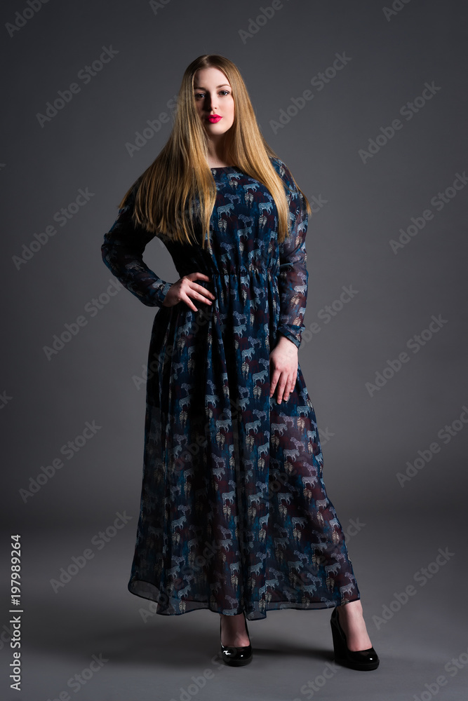 Plus size fashion model in long dress, fat woman on gray background, overweight female body Plus size fashion model in long dress, fat woman on gray background, overweight female body