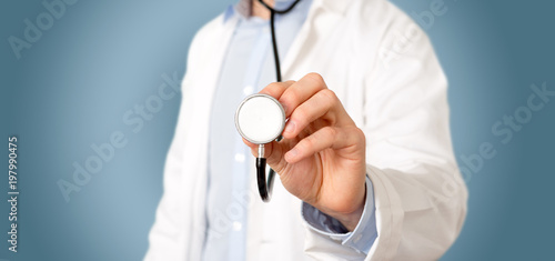 Doctor pointing using a stethoscope at the clinic photo