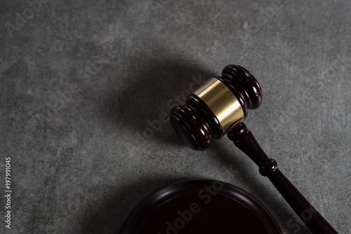 Law and Justice concept. Mallet of the judge,. Gray stone background, reflections on the floor, place for typography. Courtroom theme. photo