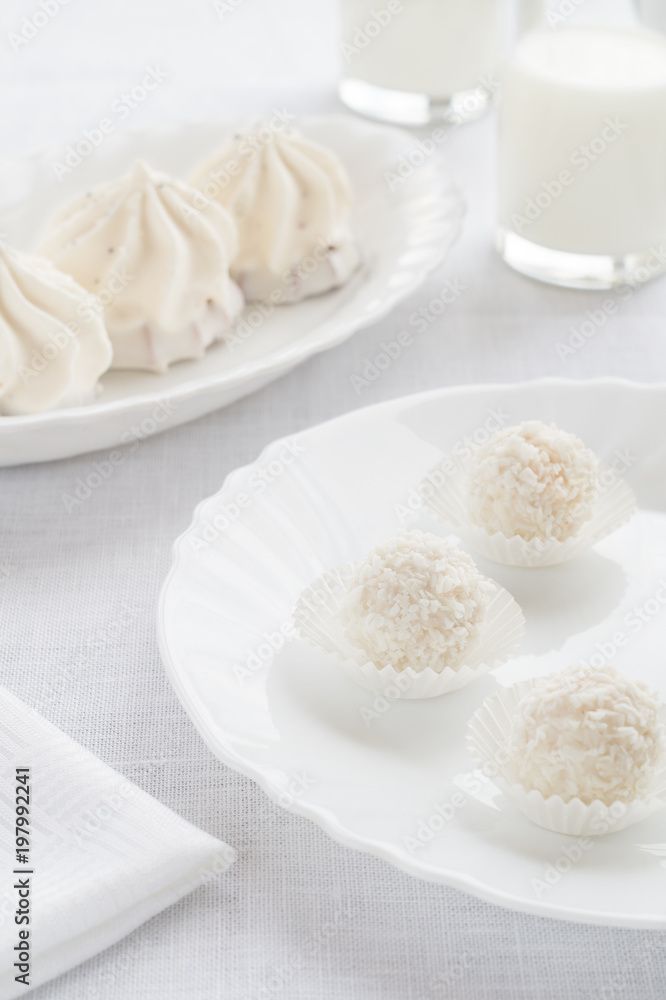 White sweets and cakes on a light background
