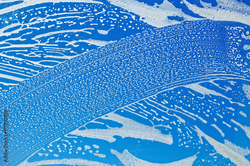 Washing windows in the house. Strip from the cleaning foam on the glass.