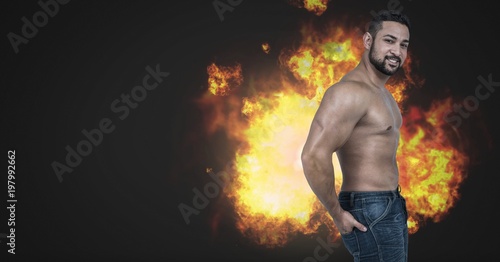 Strong muscular man with burning fire flames