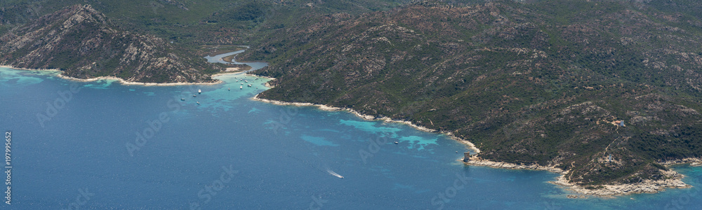 Fototapeta premium Aerial image of turquoise blue waters at the Corsican coastline West of Saint-Florent showing Punta Cavallata and Plage du Lotu