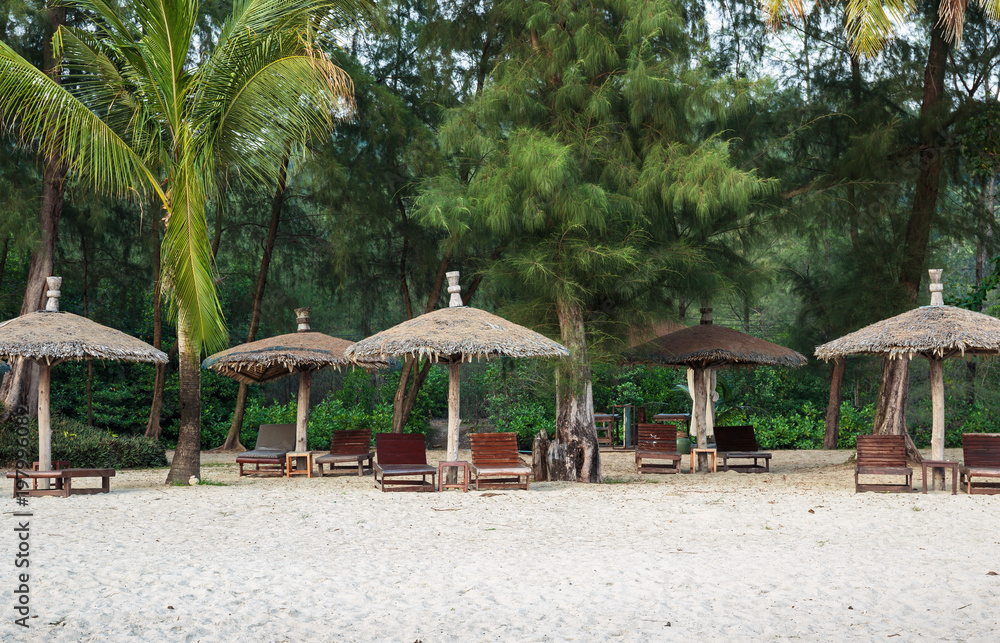 Lounge chairs and sunshade umbrella on the beach