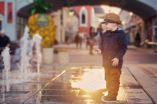 Beatifyl Sunset Scene with a Boy Watching Fountains photo