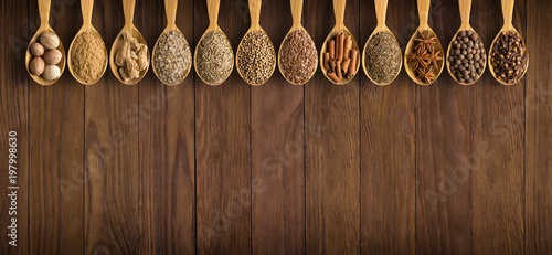 Fototapeta Naklejka Na Ścianę i Meble -  collection of Indian spices and herbs on  background  wooden table. Seasoning in spoons, top view