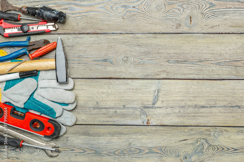 Assorted work tools on wooden table