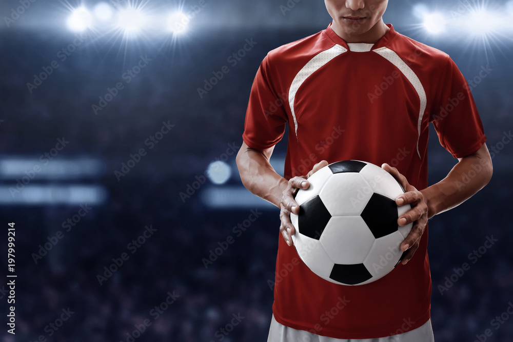 Fototapeta premium Soccer player holding soccer ball
